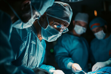Surgical Team Performing Operation in Modern OR - obrazy, fototapety, plakaty