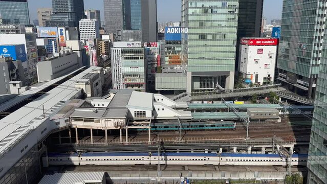 Aerial view of Akihabara station in Tokyo, Japan, with a train passing by