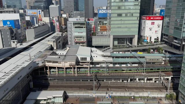 Aerial view of Akihabara station in Tokyo, Japan, with a train passing by