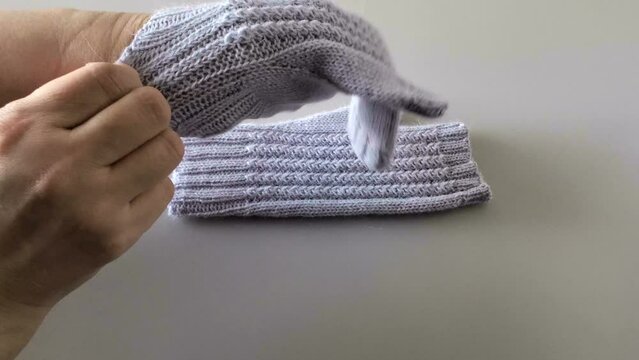 Woman wearing fingerless gloves. Hand knitted wool mittens