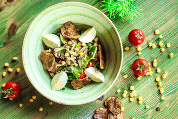 Green Bowl Filled With Food on Wooden Table