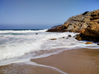 Coast of Portugal. One of the beaches in Cascais with crystal clear water. A great place for water sports - surfing.
