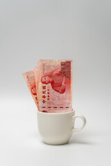 Taiwanese dollar banknote in a cup - 778693491