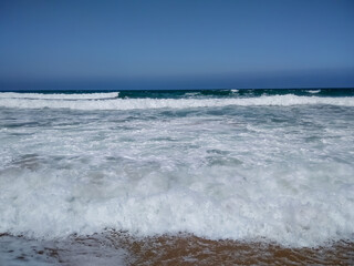 Coast of Portugal. One of the beaches in Cascais with crystal clear water. A great place for water sports - surfing.