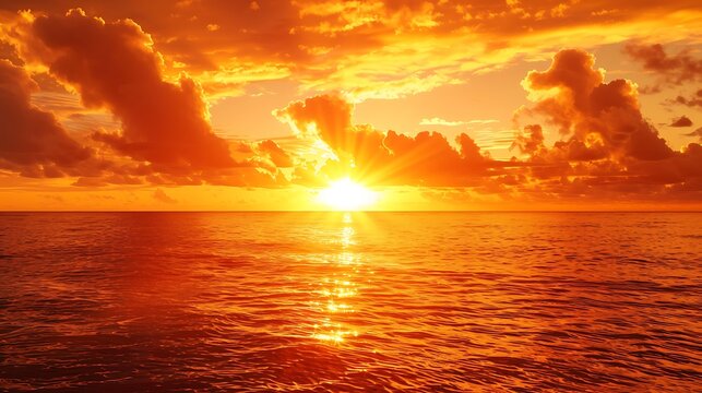 A fiery orange sunrise over a calm ocean, casting a golden glow on the water