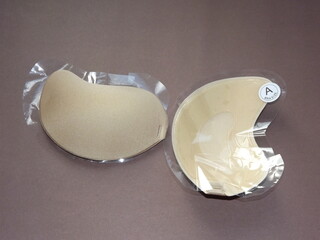 beige strapless bra close-up on different color backgrounds, size A. High quality photo