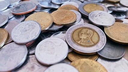 Close-up of a pile of Thai 1 baht silver coins, 2 baht silver coins, 5 baht silver coins, 10 baht silver coins, high resolution background image.