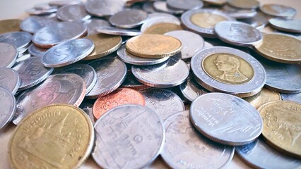 Close-up of a pile of Thai 1 baht silver coins, 2 baht silver coins, 5 baht silver coins, 10 baht silver coins, high resolution background image.