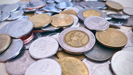 Close-up of a pile of Thai 1 baht silver coins, 2 baht silver coins, 5 baht silver coins, 10 baht silver coins, high resolution background image.