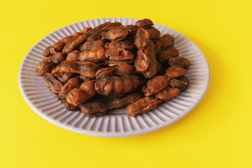 Sweet, spicy tamarind tree fruit on a plate