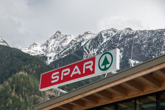 View on the publicity panel of a "spar" shop in Oets, Austria. Snowcapped mountains in the background. Early springtime. 4 april 2024, Oetz, &ouml;tztal, Austria.