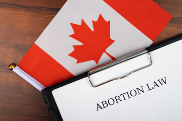Abortion law in canada, canadian flag background, debate over body autonomy, freedom of decision,...