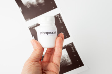 Abortion pills, oral medication, pregnant woman's hand, healthcare options