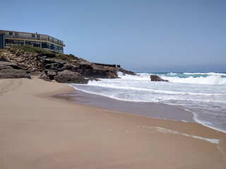 Coast of Portugal. One of the beaches in Cascais with crystal clear water. A great place for water sports - surfing.