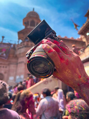 a camera colored during holi video shoot at barsana temple