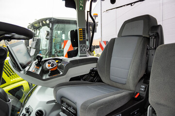 Detail of interior new tractor in an industrial environment. Interior view of tractor cabin driver...