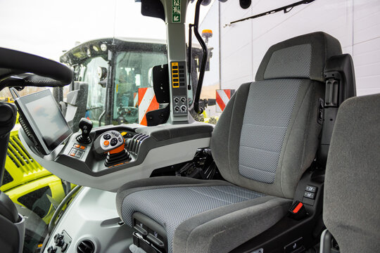 Fototapeta Detail of interior new tractor in an industrial environment. Interior view of tractor cabin driver seat. Agricultural. Interior view of cultivator tractor cabin with steering wheel. Agriculture