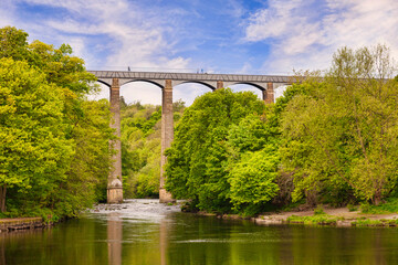 Pontcysyllte Aqueduct,  reflecting in the River Dee, with people walking across, near Llangollen, County Borough of Wrexham, Wales, UK