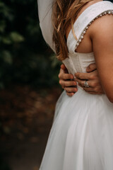The image features a woman in a white dress, possibly a wedding dress, with fashion accessories like a headpiece and