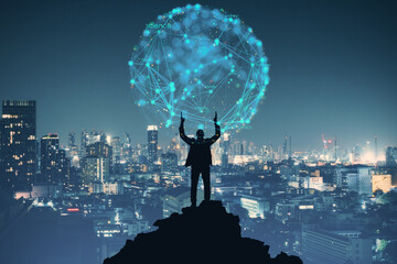 Back view of young businessman holding abstract polygonal blue sphere on dark city background. Global ambition concept.