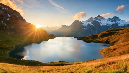 Cercles muraux Alpes fantastic evening panorama of bachalp lake bachalpsee switzerland picturesque autumn sunset in swiss alps grindelwald bernese oberland europe beauty of nature concept background