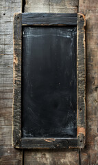 Blank chalkboard on a dark textured wooden wall with space for text.