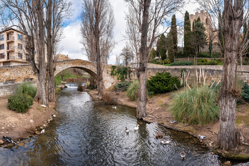 Roman stone bridge over a small stream that crosses the city of Aranda de Duero, Burgos. - obrazy, fototapety, plakaty