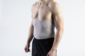 Male model orhopedic medical strap for torso white background