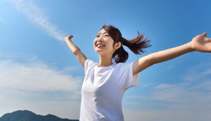 Fototapeta na wymiar 青空に羽ばたく自由な女性の幸せな瞬間