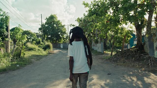 Back shot of Rastafari Man in Jamaica walking down the street
