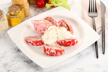 Salad with sliced tomato and stracciatella