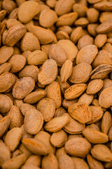 Almond nuts in a basket on a wooden background