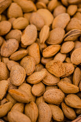 Almond nuts in a basket on a wooden background