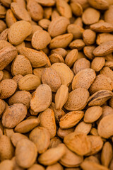 Almond nuts in a basket on a wooden background