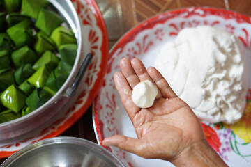 Hand hold flour bun ball for cooking traditional dessert. Concept, Thai food. How to cook, step of...