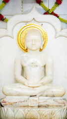 JAIN GOD IDOL picture of the deity Mahavira sculpted in white marble at a Jain temple in india...