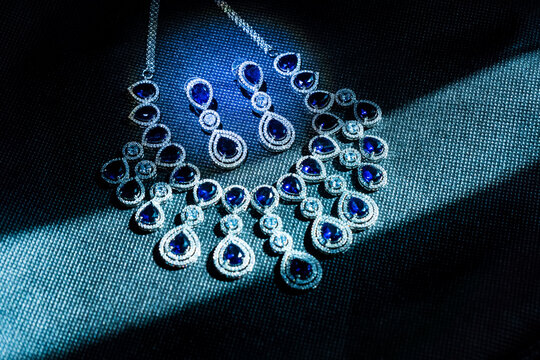 Design diamond necklace isolated on black background , Necklace made of white gold with diamonds in the dark room