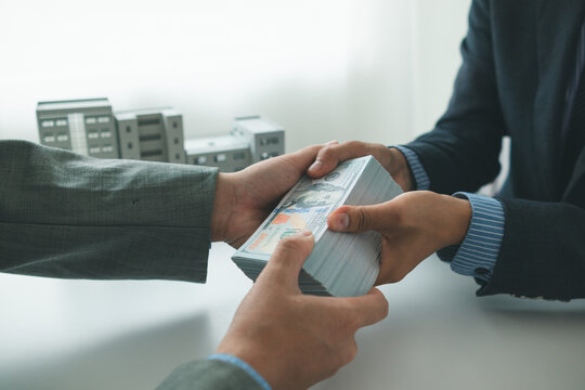 Real estate brokers are bribing government officials with cash issue construction permits in areas where high rise buildings are prohibited. Concept bribing government officials to facilitate business