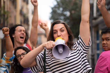 Obraz premium Transgender woman screaming during a protest to support LGBTQ community. Horizontal