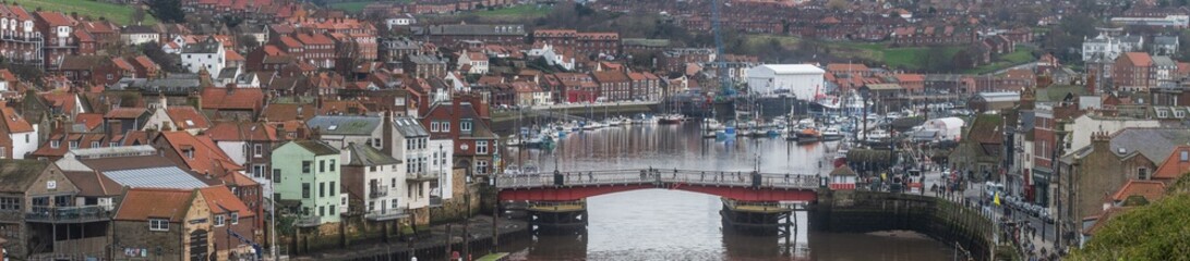 a panoramic view of Whitby in North Yorkshire showing the swing bridge over the River Esk