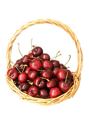 A basket of fresh fruit cherries on a white background