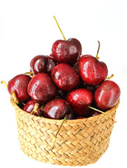 A basket of fresh fruit cherries on a white background