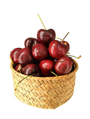 A basket of fresh fruit cherries on a white background