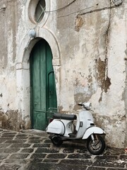Motorbike parked over building in old European town of Naples, Italy - 778767283