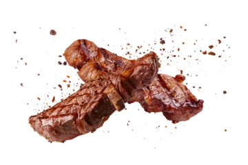 Poster Pork steak with spices isolated on a white or transparent background. Grilled pork chops, beef steaks, grilled pieces of meat flying in the air. Barbecue meat graphic element. © SERSOLL