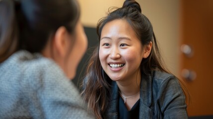 The photograph exhibits two individuals in a casual conversation in an office setting, suggesting a sense of collaboration and engagement