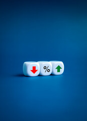 Percentage icon in middle of red down and green up arrows on white cube block on blue background, vertical style. Interest rate, financial stocks, ranking, GDP percent change, money exchange concepts.