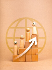 Population and aging, The growing elderly population concepts. Rising up white arrows on wooden cube block graph steps with old people face, wooden figures on brown background with globe earth symbol.