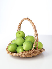 A basket of fresh fruit dates on a white background