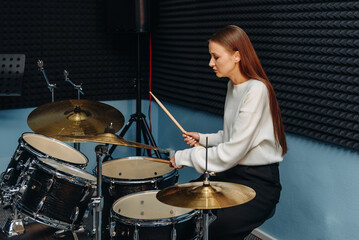 young woman playing drum set